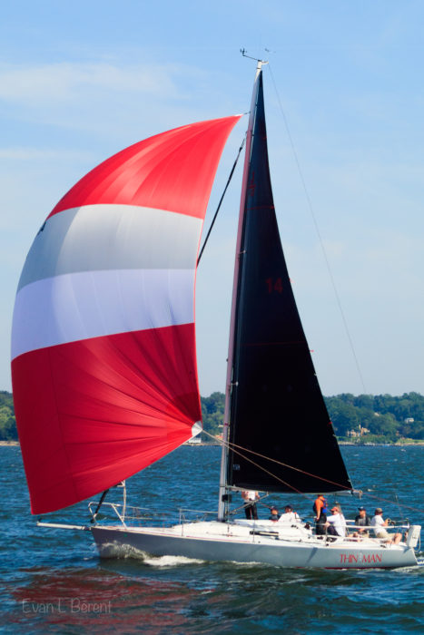 Thin Man sails downwind with a spinnaker in Eastchester bay