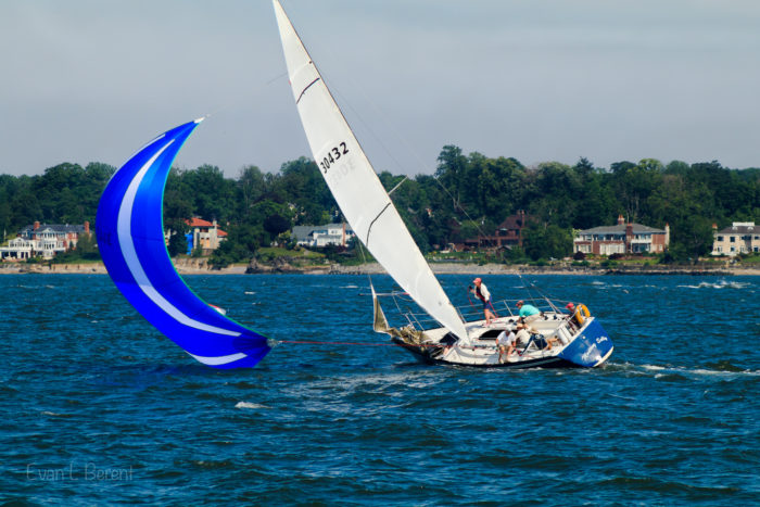A sailboat broaching during a sailboat race in Eastchester Bay, New York