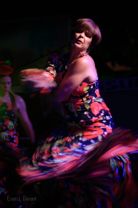 A colorful flamenca dancer in the spotlight during Corpus Cristi in Granada.